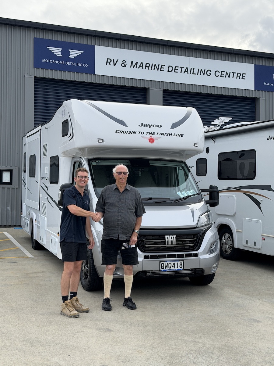 Harry King shaking hands with a happy motorhome owner outside the Mount Wellington RV & Marine Detailing Centre