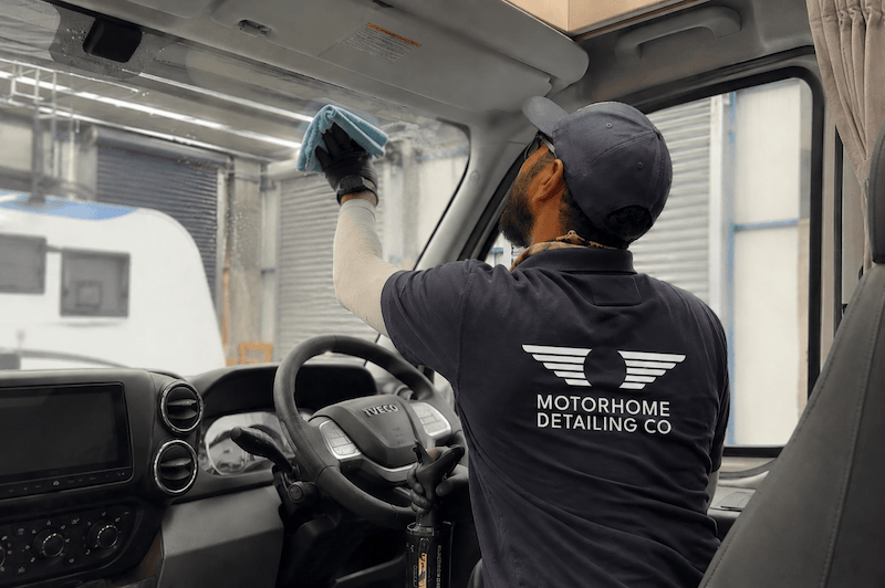 Motorhome Detailing Co technician cleaning interior windscreen of motorhome cab